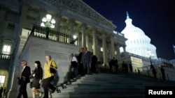 Para anggota DPR AS meninggalkan Gedung Capitol setelah melakukan pemungutan suara larut malam untuk RUU fiskal (16/10). (Reuters/Jonathan Erns)