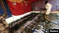 Rapid Support Forces display disarmed weapons during Sudanese President's Omar al-Bashir visit to the war-torn Darfur region at Rapid Support Forces Headquarter in Umm Al-Qura, Darfur, Sudan, Sept. 23, 2017. 