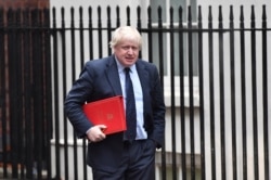 FILE - Boris Johnson, then Britain's foreign secretary, arrives at 10 Downing Street for a weekly meeting of the cabinet, in central London, Britain, Dec 11, 2017.