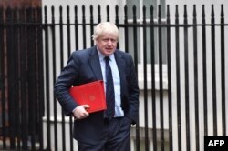 FILE - Boris Johnson, then Britain's foreign secretary, arrives at 10 Downing Street for a weekly meeting of the cabinet, in central London, Britain, Dec 11, 2017.