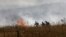 Israeli firefighters put out flames in a field after rockets launched from southern Lebanon landed on the outskirts of Katzrin in the Israel-annexed Golan Heights on June 2, 2024.