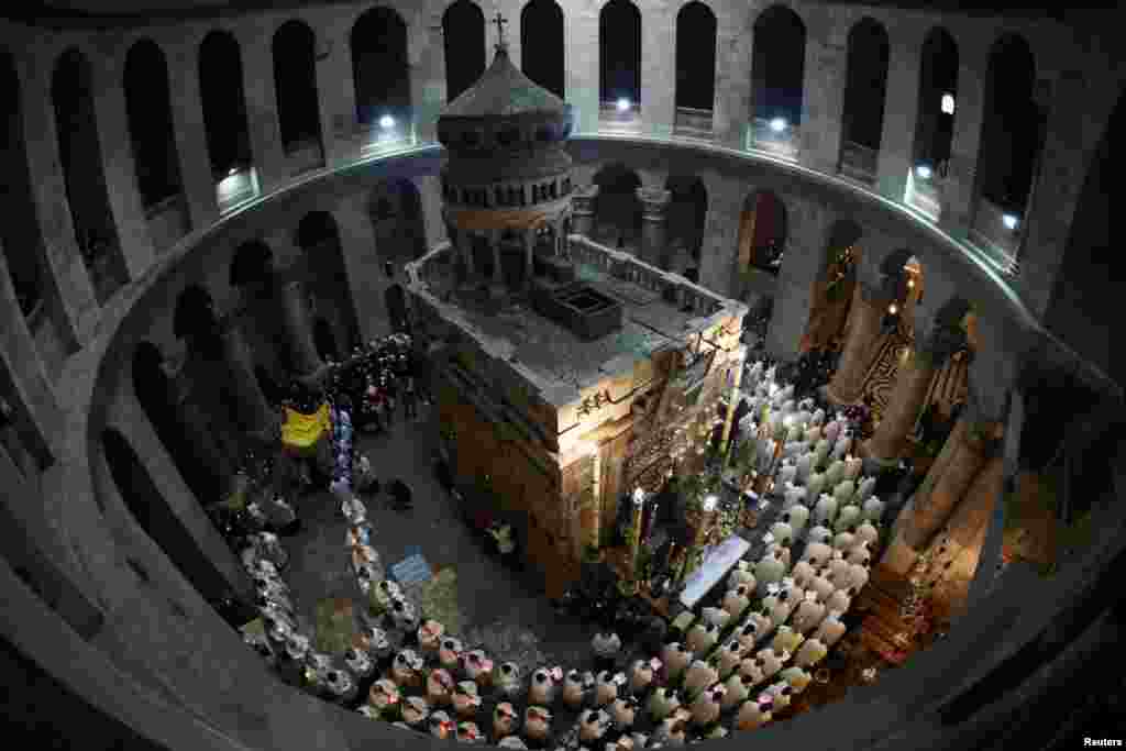 Worshippers take part in a procession during the Catholic Washing of the Feet ceremony during Easter Holy Week in the Church of the Holy Sepulchre, in Jerusalem&#39;s Old City.