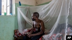 FILE - A man suffering from mpox waits for treatment at the Kamituga General Hospital in South Kivu, Congo, on Sept. 4, 2024.