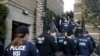 FILE - Federal agents enter an upscale apartment complex where authorities say a birth tourism business charged pregnant women $50,000 for lodging, food and transportation, in Irvine, California, March 3, 2015.