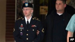 Army Pfc. Bradley Manning is escorted out of a courthouse after the start of the sixth week of his court martial, in Fort Meade, Maryland, July 8, 2013.