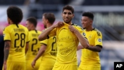 Achraf Hakimi of Borussia Dortmund exposes a 'Justice for George Floyd' shirt during a German Bundesliga soccer match between SC Paderborn 07 and Borussia Dortmund at Benteler Arena in Paderborn, Germany, May 31, 2020. 