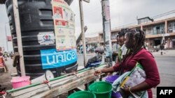 FILE - Women wash their hands at a hand-washing station set up to help fight Ebola transmissions, in Goma, Democratic Republic of Congo, July 31, 2019.