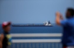 FILE - The oil supertanker Grace 1, that's on suspicion of carrying Iranian crude oil to Syria, sits anchored in waters of the British overseas territory of Gibraltar, historically claimed by Spain, July 4, 2019.
