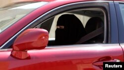 A woman drives a car in Saudi Arabia on October 22, 2013. Saudi Arabia is the only country in the world where women are barred from driving, but debate about the ban is growing. 