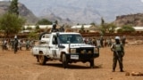 FILE - Rwandan peacekeepers, part of the U.N.-African Union mission in Darfur (UNAMID), stand guard in the town of Golo, in central Darfur, Sudan, June 19, 2017. The peacekeepers recently handed over 14 Darfur bases to Sudan's control.