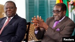 Zimbabwean President Robert Mugabe (R) and Prime Minister Morgan Tsvangirai address a media conference in Harare, January 17, 2013.