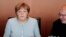 German Chancellor Angela Merkel, left, listens to chief of staff Peter Altmaier during a Cabinet meeting at the chancellery in Berlin, July 6, 2016.