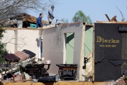 People work at a damaged home in Chattanooga, Tenn., April 14, 2020.