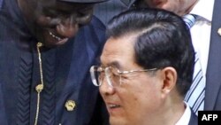 President of China Hu Jintao looks on as President of Nigeria Goodluck Jonathan speak during the family photograph of the 2012 Nuclear Security Summit in Seoul, March 27, 2012. 