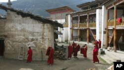 FILE - Tibetan nuns walk through the grounds of the Taibaling Nunnery at Shusong Village, in the mountains about 50 kilometers (31 miles) from the border with Tibet, in China's southwest Yunnan province Tuesday March 25, 2008. The nunnery was rebuilt on the site of a 300-year-old monastery after the monastery and the nearby nunnery were destroyed during China's 1966-76 Cultural Revolution. Some 130 Tibetan nuns currently study at the nunnery.