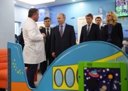 Russian President Vladimir Putin, third from left, visits a children's clinic during a trip to Ivanovo, Russia, March 6, 2020.