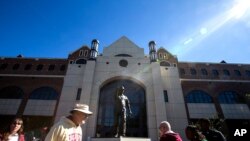 Florida State fans walk past the statue of former coach Bobby Bowden before an NCAA college football game against Miami in Tallahassee, Fla., Nov. 2, 2019.