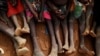 FILE - Orphans and children separated from their parents in Kadugli gather to eat boiled leaves at an internally displaced persons camp in South Kordofan, Sudan, June 22, 2024.