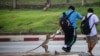 FILE - A long-tailed macaque takes food from a local student near Phra Prang Sam Yot temple, in Lopburi, Thailand, June 7, 2024. ( REUTERS/Chalinee Thirasupa)