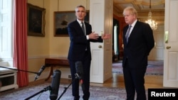 NATO Secretary-General Jens Stoltenberg gestures as he speaks next to Britain's Prime Minister Boris Johnson during a news conference following their meeting at Downing Street in London, Britain, June 2, 2021. 
