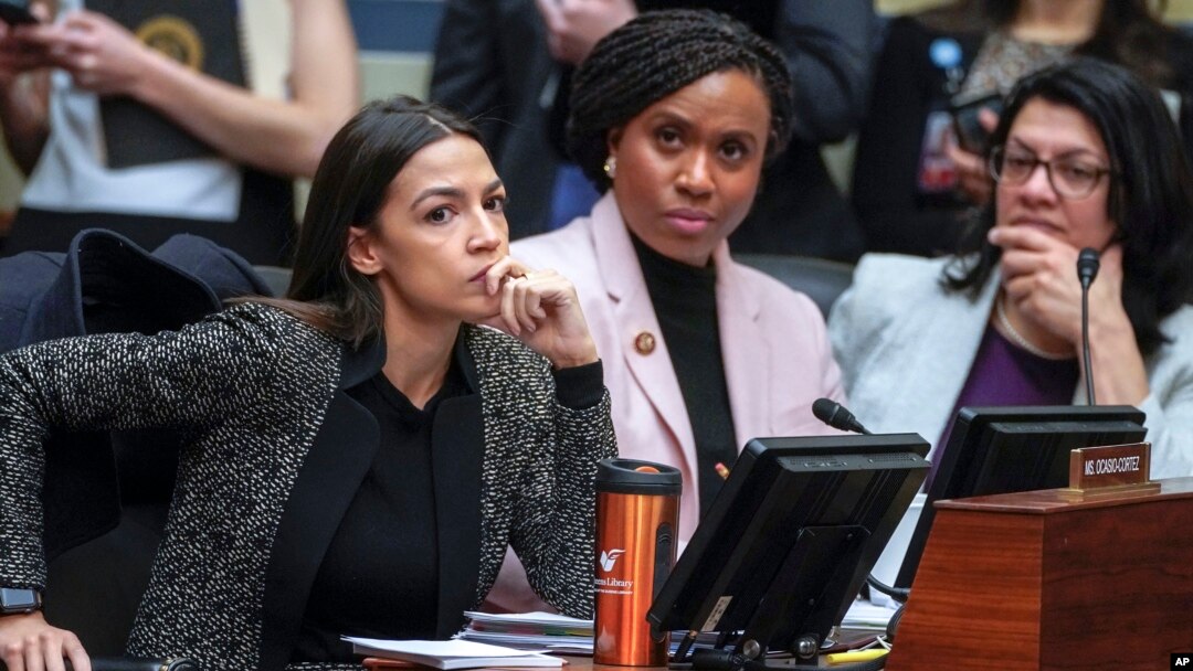 FILE - Rep. Alexandria Ocasio-Cortez, D-N.Y., left, joined by Rep. Ayanna Pressley, D-Mass., and Rep. Rashida Tlaib, D-Mich., listens during a House Oversight and Reform Committee meeting, on Capitol Hill in Washington, Feb. 26, 2019. 