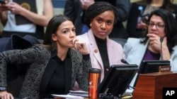 FILE - Rep. Alexandria Ocasio-Cortez, D-N.Y., left, joined by Rep. Ayanna Pressley, D-Mass., and Rep. Rashida Tlaib, D-Mich., listens during a House Oversight and Reform Committee meeting, on Capitol Hill in Washington, Feb. 26, 2019. 