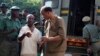 FILE: Former U.S. congressman Mel Reynolds (C) arrives at the Harare Magistrates court, Feb. 20, 2014. 