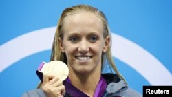 Dana Vollmer of the U.S. holds her gold medal during the women's 100m butterfly victory ceremony during the London 2012 Olympic Games at the Aquatics Centre July 29, 2012. 