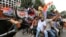 Congress party supporters shout slogans as they ride on bullock carts during a protest against fuel price hike and other economy issues in Bangalore, India, Sept. 10, 2018.