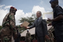 FILE - Victor Tokmakov, first secretary of the Russian Embassy, presents diplomas to graduating recruits in Berengo, Central African Republic, Aug. 4, 2018. Russian military consultants set up training for the Central African armed forces.