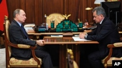 Russian President Vladimir Putin, left, meets with Defense Minister Sergei Shoigu in the Novo-Ogaryovo residence outside Moscow, Dec. 8, 2015.