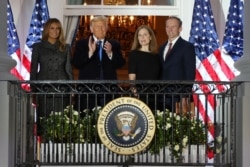 U.S. Supreme Court Associate Justice Amy Coney Barrett poses with first lady Melania Trump, President Donald Trump and her husband Jesse Barrett on the balcony of the White House after taking her oath of office Oct. 26, 2020.