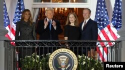 U.S. Supreme Court Associate Justice Amy Coney Barrett poses with U.S. first lady Melania Trump, President Donald Trump and her husband Jesse Barrett on the balcony of the White House after taking her oath of office to serve on the U.S. Supreme Court.