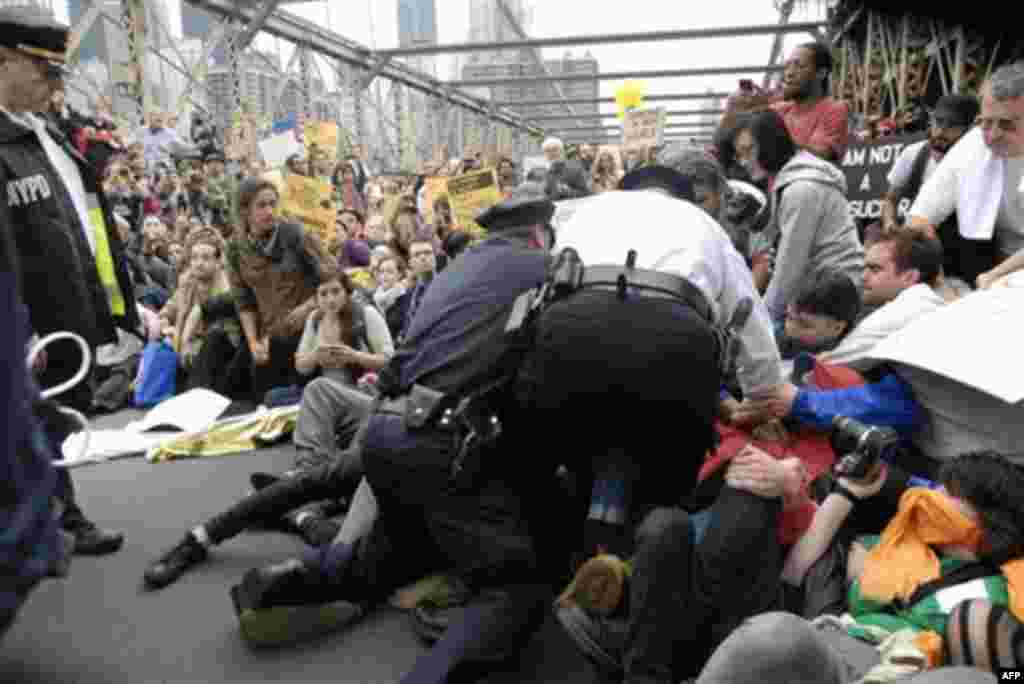 In this Oct. 1, 2011 photo, police make their way a crowd of protesters who were the front line on New York's Brooklyn Bridge when police began making arrests during Saturday's march by Occupy Wall Street. Protesters speaking out against corporate greed a