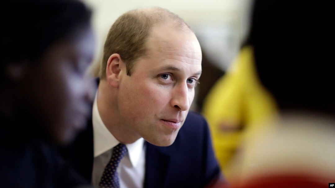 Britain's Prince William speaks with families who have lost loved ones during his visit to a child bereavement center in Stratford in east London, Jan. 11, 2017.