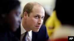 Britain's Prince William speaks with families who have lost loved ones during his visit to a child bereavement center in Stratford in east London, Jan. 11, 2017.