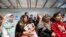 FILE - Syrian refugees wait to receive treatment at a health center, during the visit of Slovenian President Borut Pahor (back C) to the refugee camp Al-Zaatari in Jordan, near the border with Syria, Dec. 3, 2016.