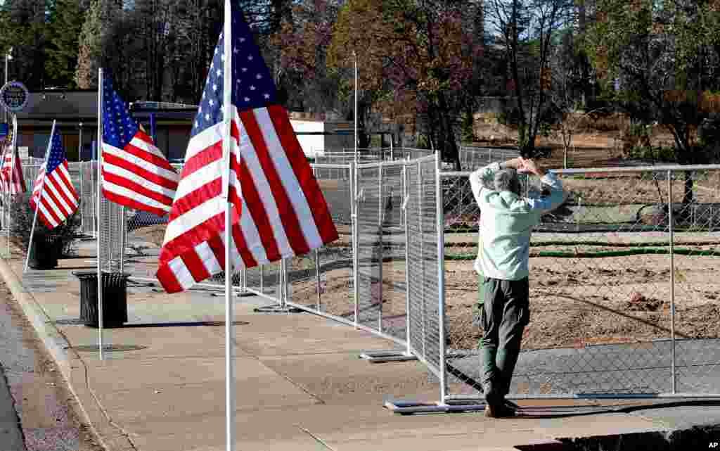 Robert Bean pauses at lot where a building was destroyed in last years Camp Fire in Paradise, Calif., Nov. 8, 2019.
