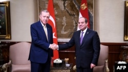 FILE - A handout picture released by the Egyptian Presidency shows Egyptian president Abdel Fattah al-Sisi (R) receiving his Turkish counterpart President Recep Tayyip Erdogan, at the presidential hall at Cairo International Airport on February 14, 2024.
