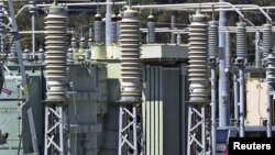 Grids at the Pacific Gas & Electric plant next to new construction on a hill near San Francisco, March 29, 2001.