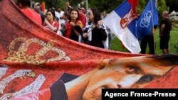 Members of the local Serbian community hold flags and banners outside a government detention center where Serbia's tennis champion Novak Djokovic is staying in Melbourne, Australia, on Jan. 8, 2022.