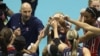 Hugh McCutcheon, top left, head coach of US women's volleyball team, bumps fists with players during game against Germany in Rio de Janeiro. (2009 photo)