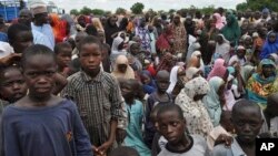 Civilians who fled their homes following an attack by Islamist militants take refuge at a school in Maiduguri, Nigeria, Tuesday, Sept. 9, 2014.