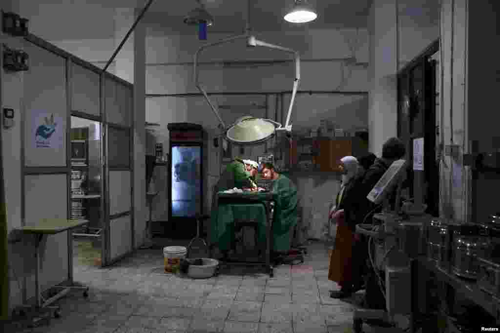 Doctors treat an injured civilian in a field hospital after what activists said was shelling by forces of Syria's President Bashar al-Assad in the Douma neighborhood of Damascus.