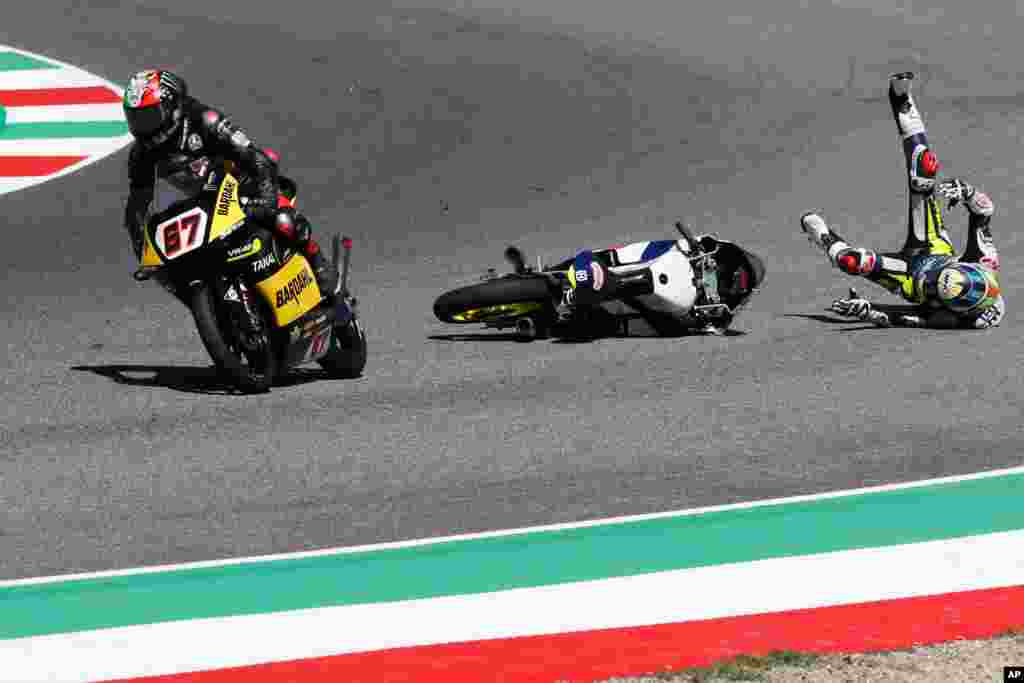 Husqvarna rider Adrian Fernandez, right, crashes during the Moto 3 Grand Prix of Italy at the Mugello circuit in Scarperia, Italy.