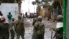 An opposition supporter throws a stone at riot police in Kibera Slums in Nairobi, Kenya, Thursday, Oct. 26, 2017.