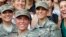 U.S. Army First Lt. Shaye Haver, center, and Capt. Kristen Griest, right, pose for photos with other female West Point alumni after an Army Ranger school graduation ceremony, at Fort Benning, Georgia, Aug. 21, 2015.