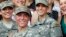 U.S. Army First Lt. Shaye Haver, center, and Capt. Kristen Griest, right, pose for photos with other female West Point alumni after an Army Ranger school graduation ceremony, Aug. 21, 2015, at Fort Benning, Ga. 