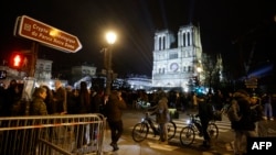 Crowds gather in front of Notre Dame Cathedral in Paris on the eve of its official reopening after more than five years of reconstruction work following the April 2019 fire, Dec. 6, 2024.