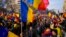 Protesters walk holding Romanian flags during a rally calling for free elections after Romania' s Constitutional Court annulled the first round of presidential elections, in Bucharest, Jan.12, 2025. 